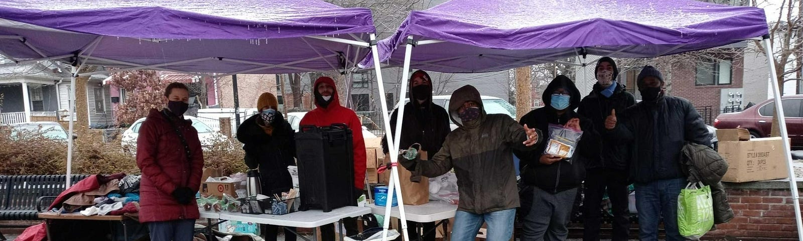 Ward 4 Mutual Aid Unhoused Advocacy members standing under tents at original Georgia Avenue Washington DC location on icy day