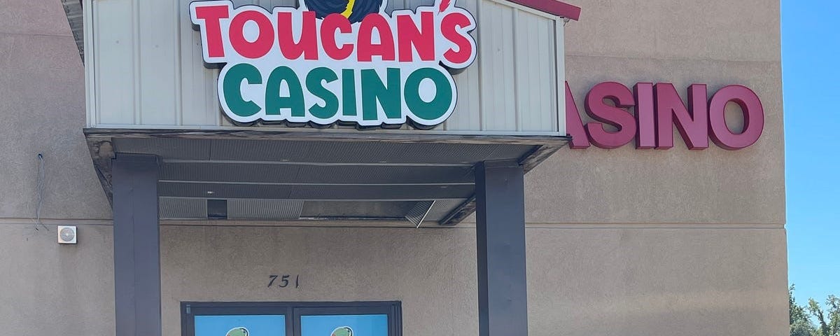 Picture of Toucan above the door of a casino named Toucan’s Casino.