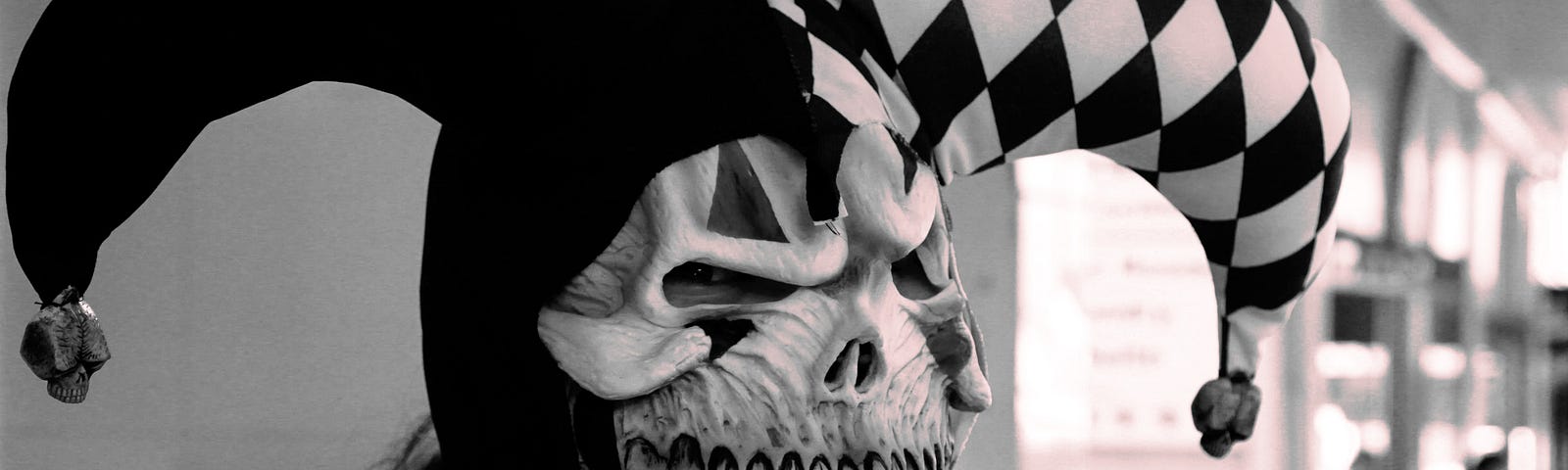 Terrifying skeleton clown in black and white jester costume