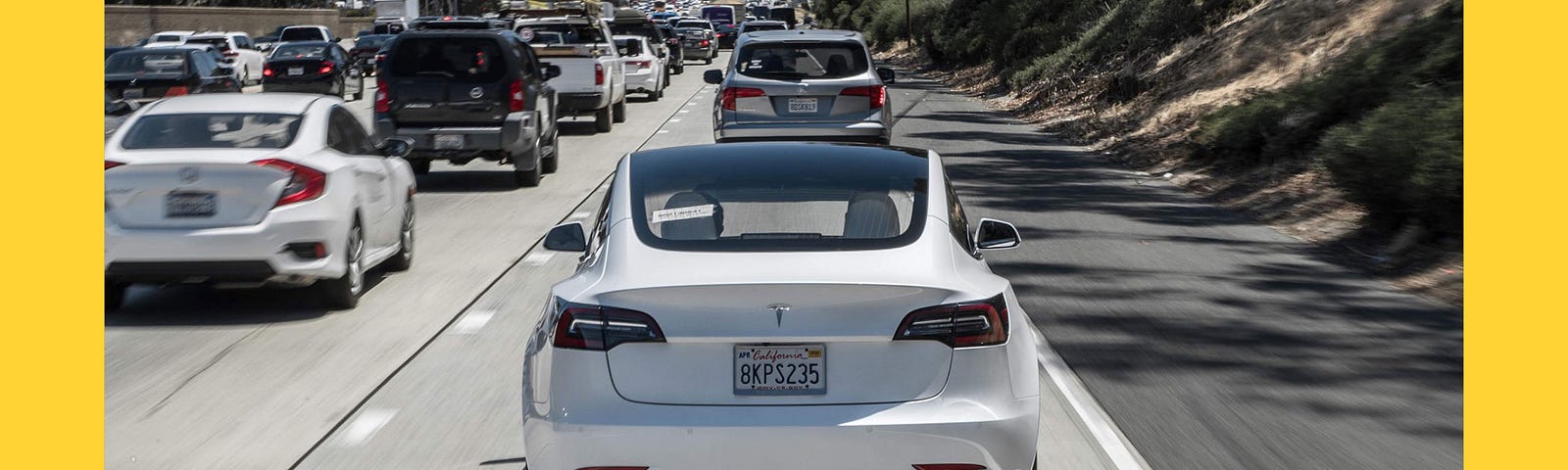 A Tesla driving in freeway traffic