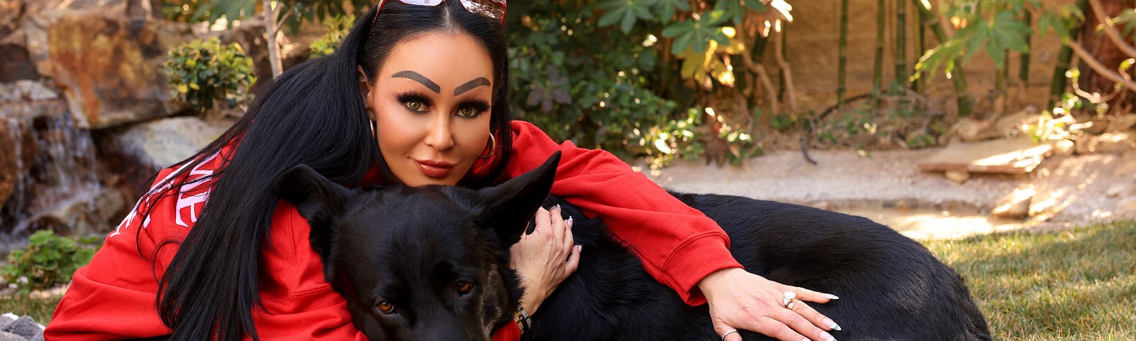 Woman in red top with her German Shepherd.