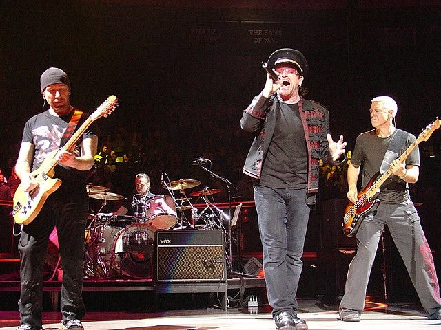 The band U2 performing in concert.
