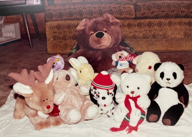 A collection of stuffed animals sits on the floor.