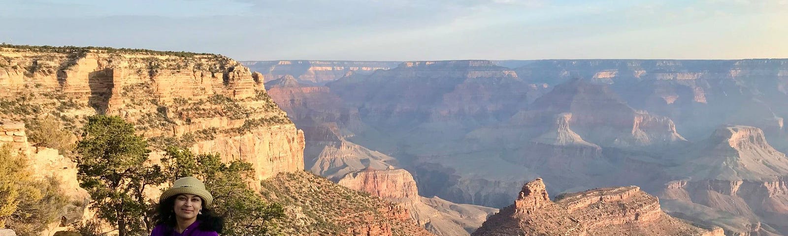 Author by the ledge overlooking the Grand Canyon at sunrise.