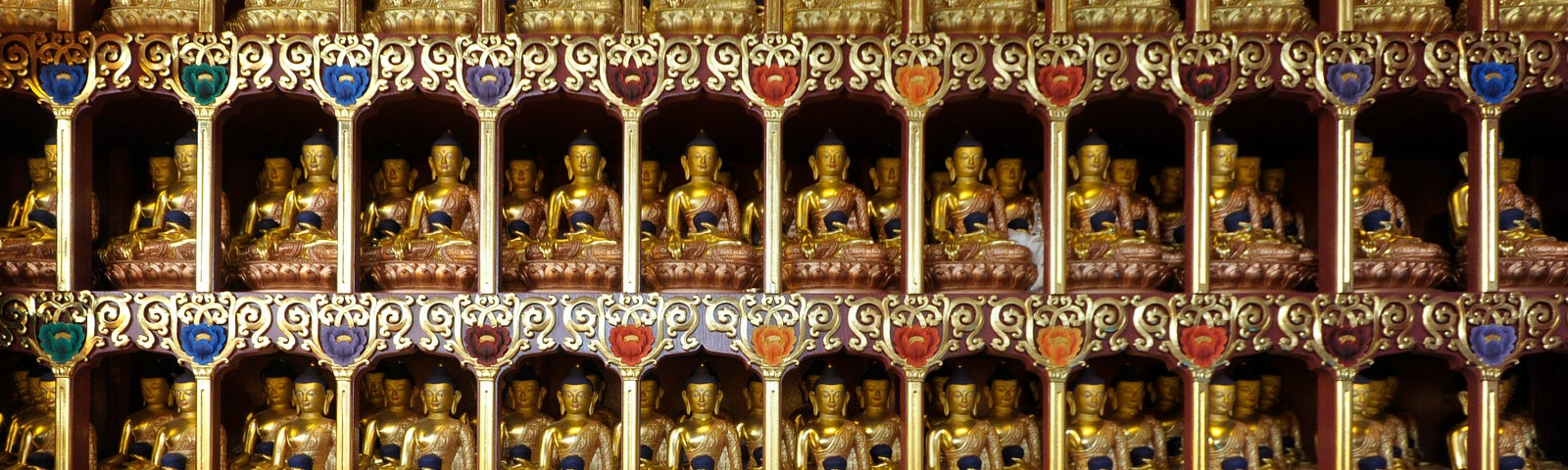 many small buddha statues on an altar