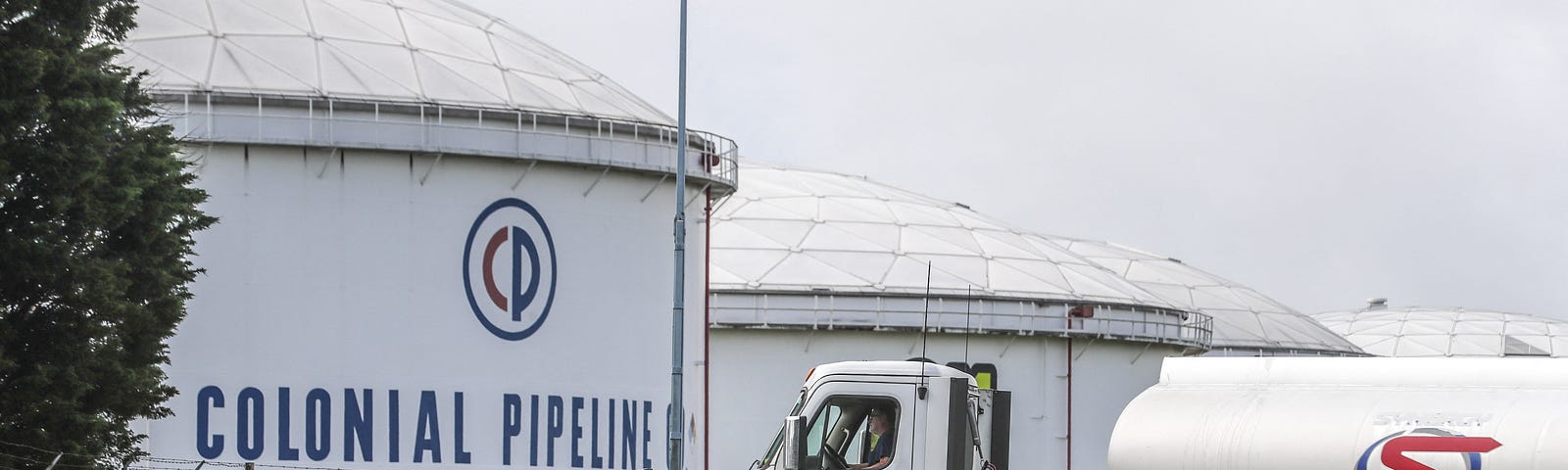 Gasoline tankers pass by Colonial Pipeline storage tanks in Austell, Georgia, May 10, 2021. Photo by John Spink/The Atlanta Journal-Constitution/TNS/ABACAPRESS.COM