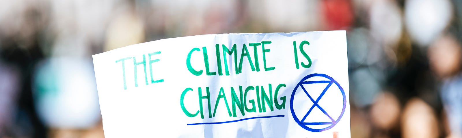 Banner that reads, “The climate is changing, so should we”