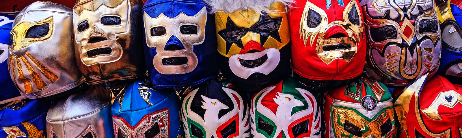 A booth in a mexican flea market that offers numerous different wrestling masks.