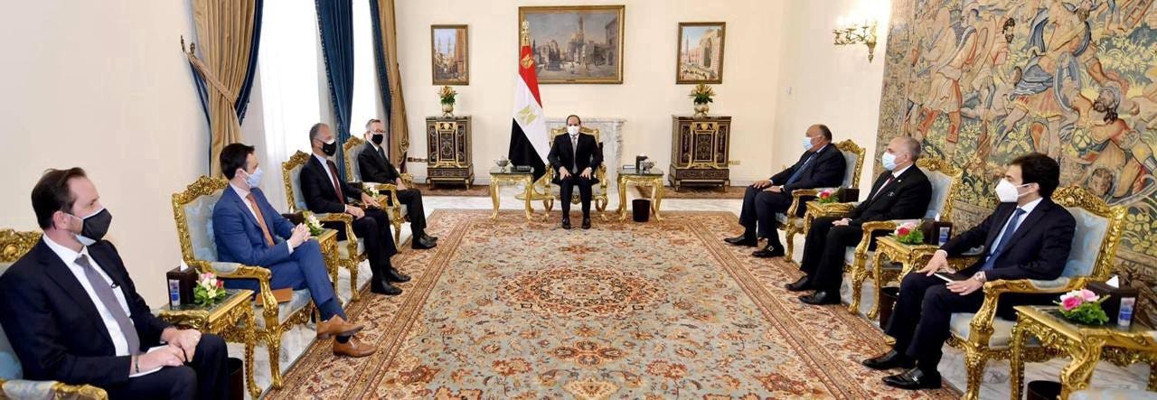 Diplomats sit facing each other during a meeting with Egyptian President Sisi