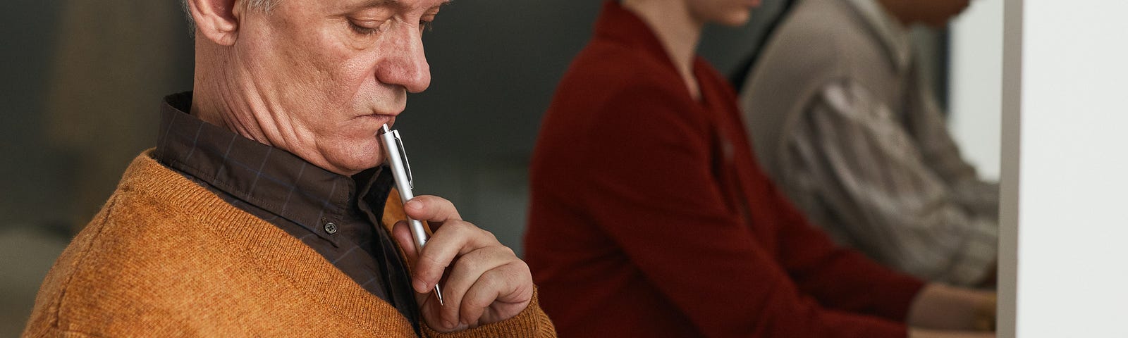 A senior voter examines his ballot before selecting candidates.