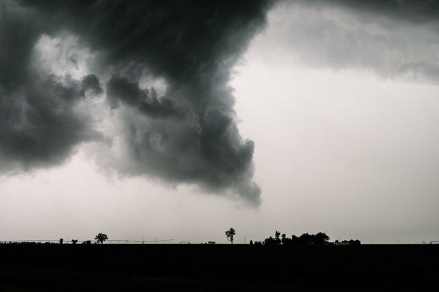 a gray and black wind forming a tornado over the plains