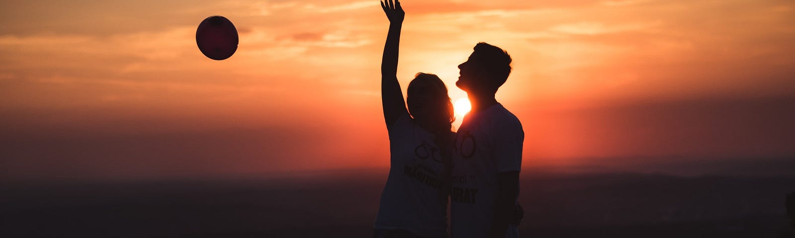 Silhouette photo of couple standing outdoor, at dusk