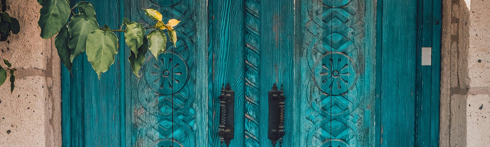A rustic blue-green doorway