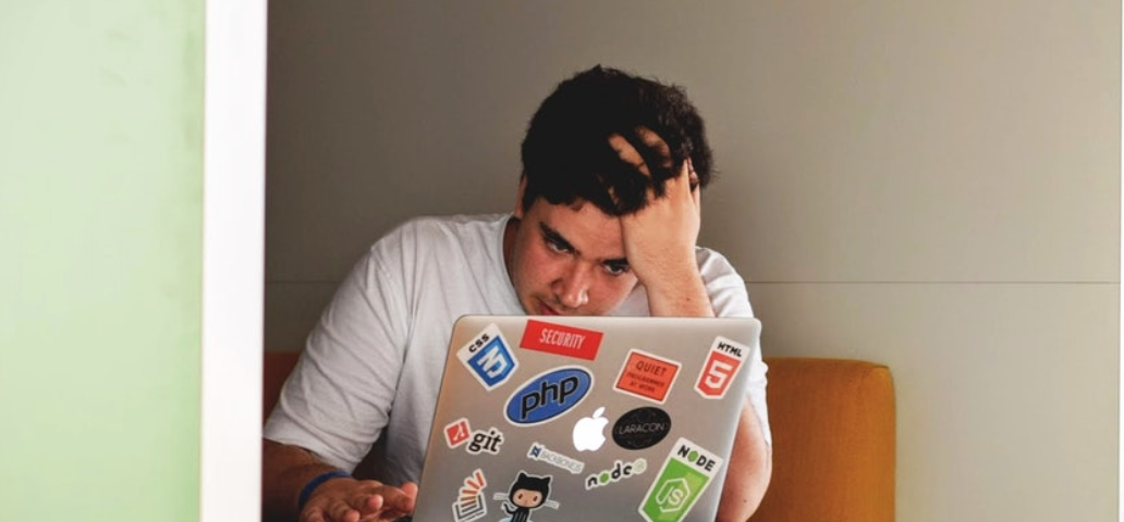 Stressed man working on his laptop