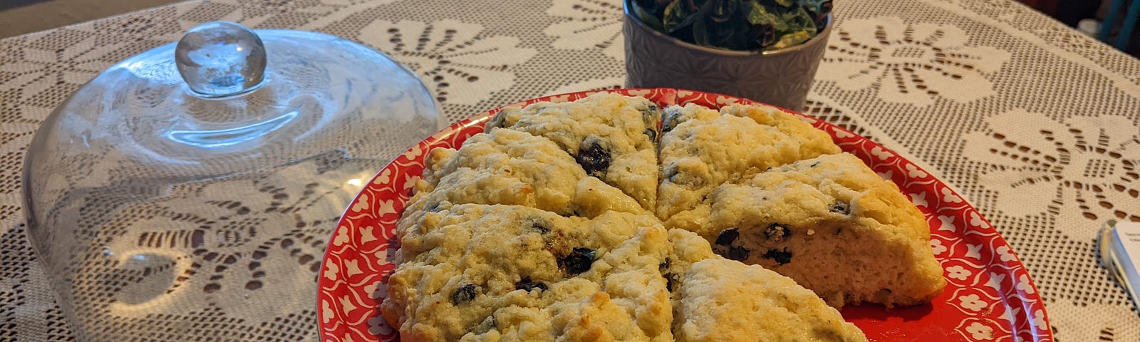 blueberry scones sitting on a red cake plate.