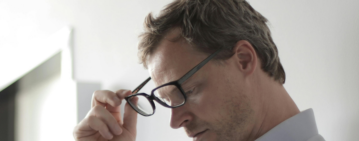 photo-of-man-holding-black eyeglasses