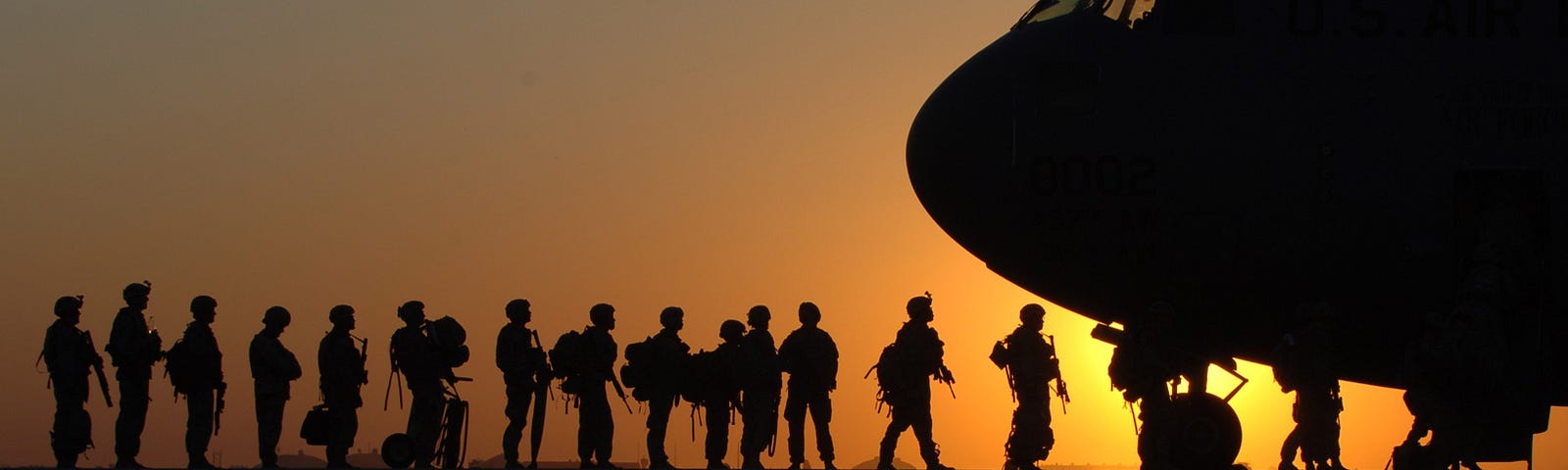 US Military troops boarding a plane.