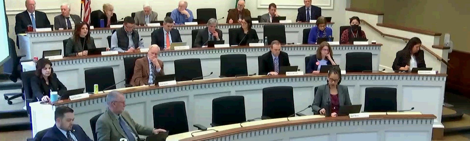 A screenshot of legislators sitting in session with an overlay from TVW