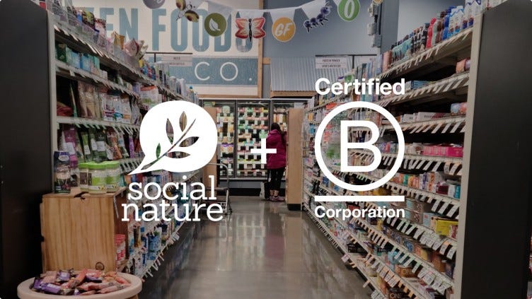 the social nature logo and certified B Corp logo are displayed in white overtop an image of a grocery store isle with good for you products lining each side of the aisle.