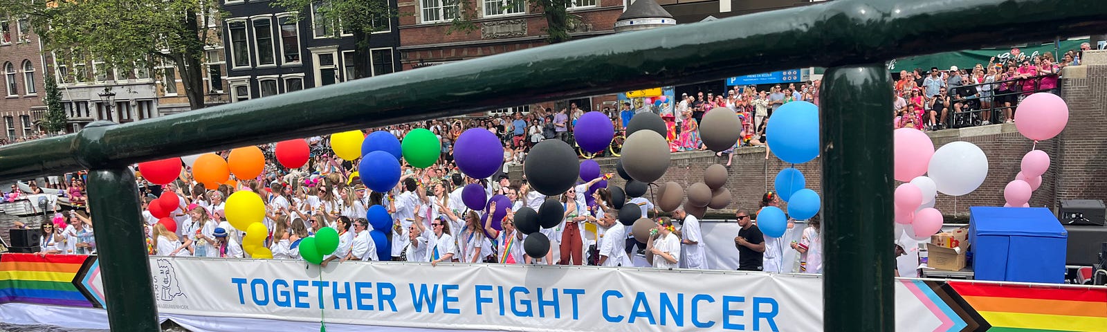 This is a photo of a canal boat that shows a sign saying, “together we fight cancer”.