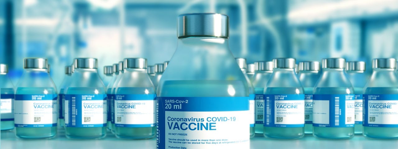 IMAGE: A vial labeled as of Coronavirus COVID-19 vaccine in front of a row of many other vials