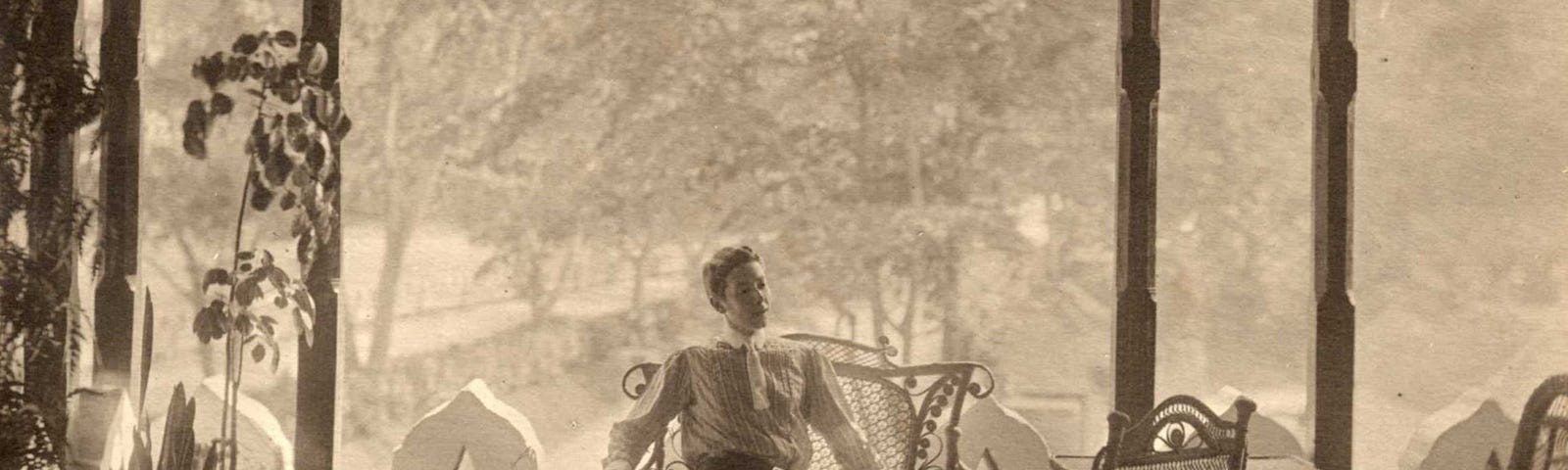 Adolf de Meyer sits on a bench as light illuminates him.