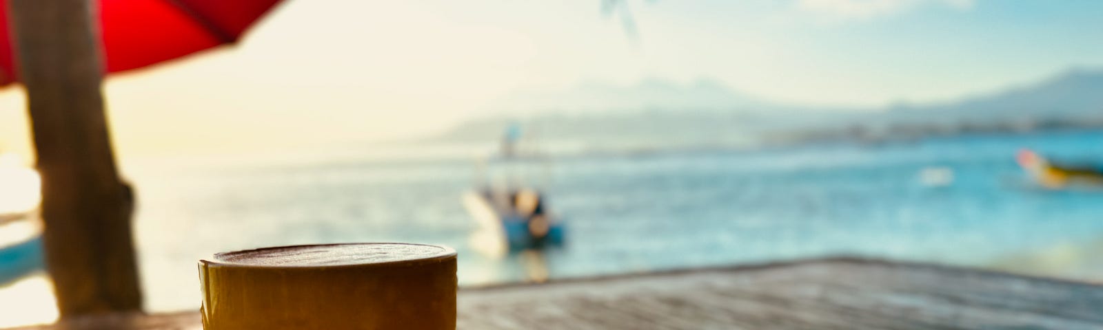 A cup of coffee ona table overlooking the water in Bali.