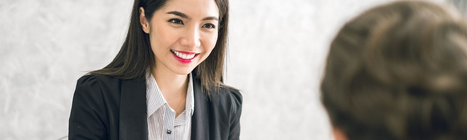 Asian business woman discussing/job interview with colleague/boss for business meeting