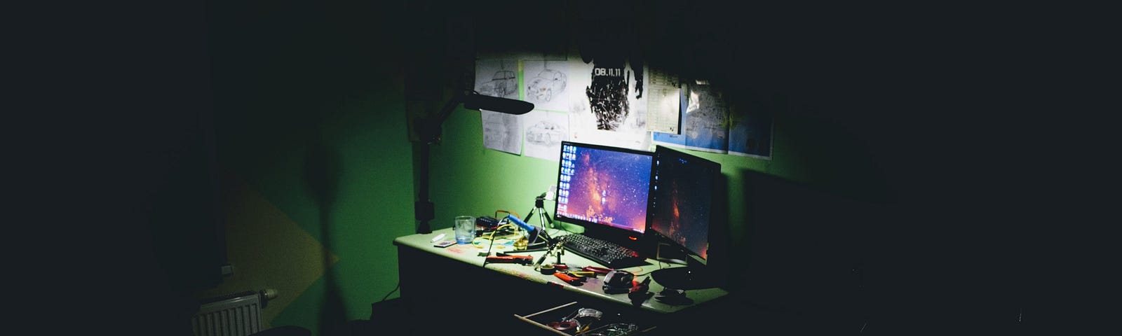 an image of two computer monitors on a desk to represent a hacker’s work station where they might conduct data breaches.