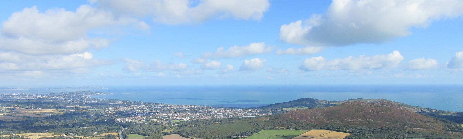 view from top of a mountain in Wicklow Ireland with the Irish Seain the background