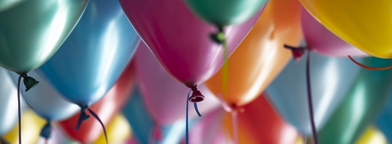 High definition image of different coloured balloons in a room
