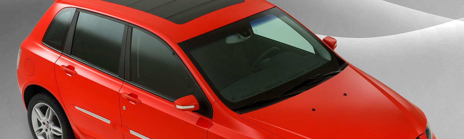 Fiat Stilo Sporting, na cor Vermelho Modena, visto de cima e da dianteira, mostrando o teto solar Sky Window.