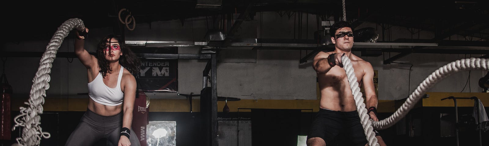 Man And Woman Holding Battle Ropes