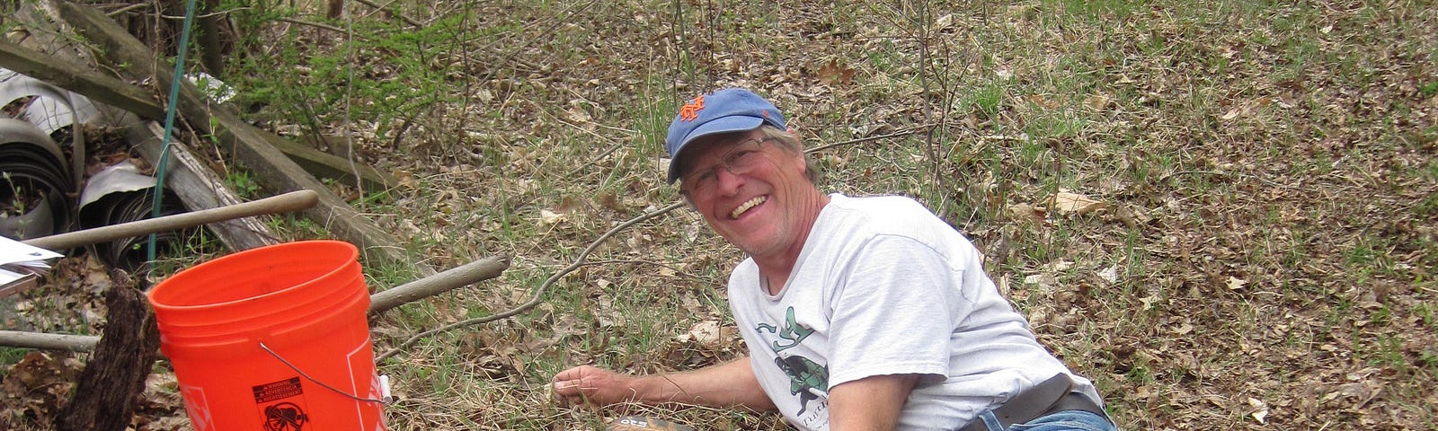 A man in a field lines up turtles by size