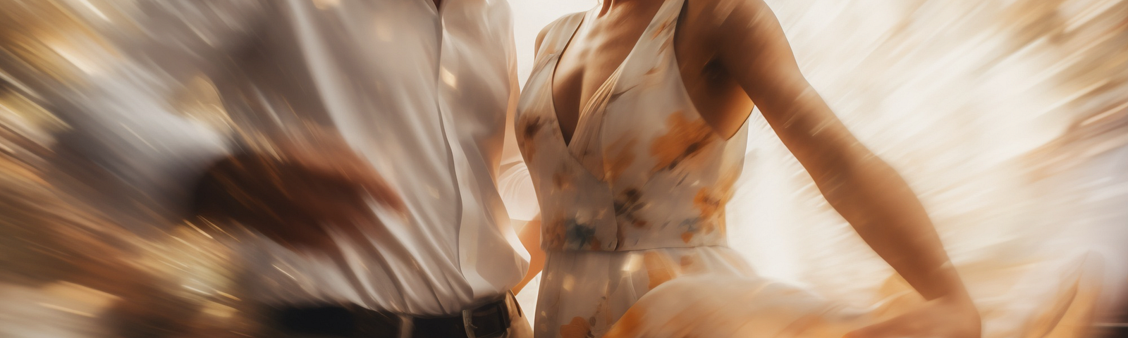 A color photograph of a male and female couple dancing closely with the woman’s dress swirling in the breeze