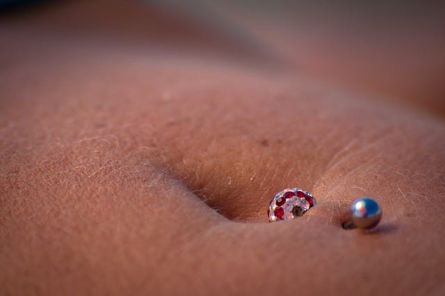 Close of of body jewellery — navel piercing