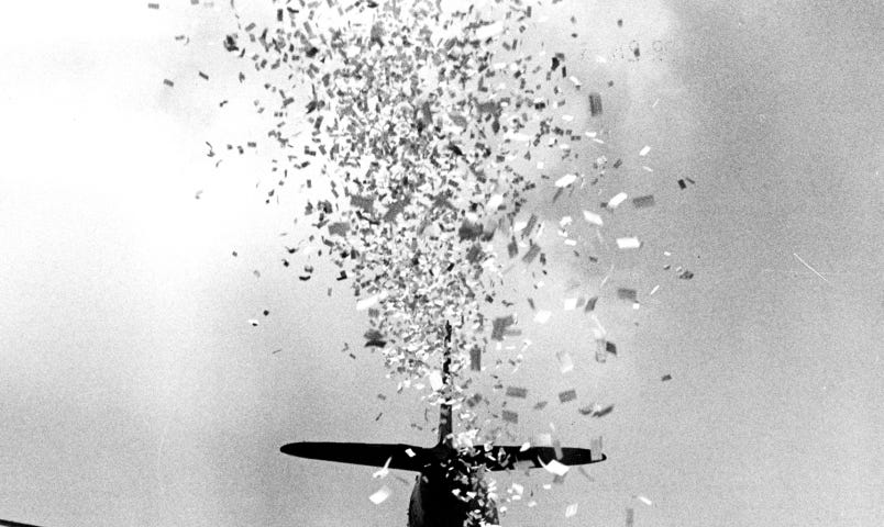 IMAGE: A war plane in black and white throwing flyers over Japan during World War II