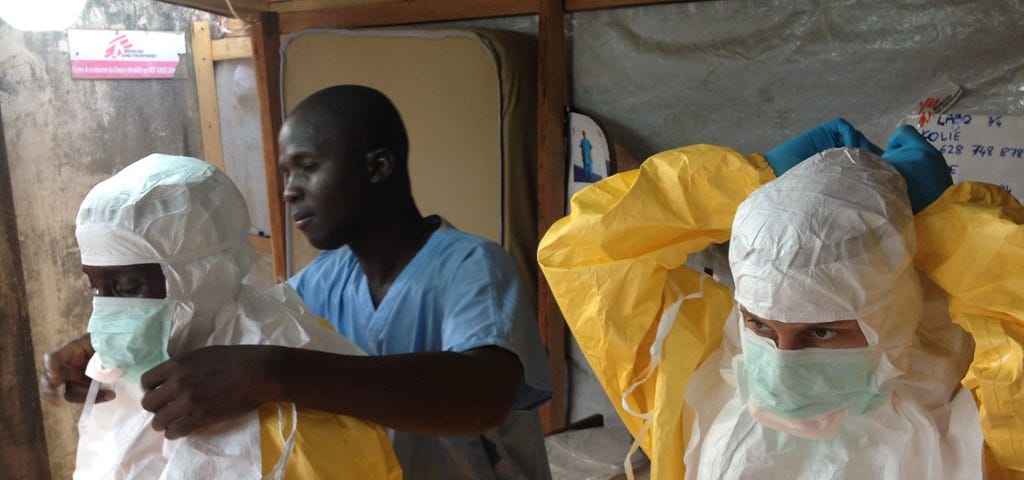 Healthcare workers in protective gear fighting the Ebola outbreak in Guinea in 2014