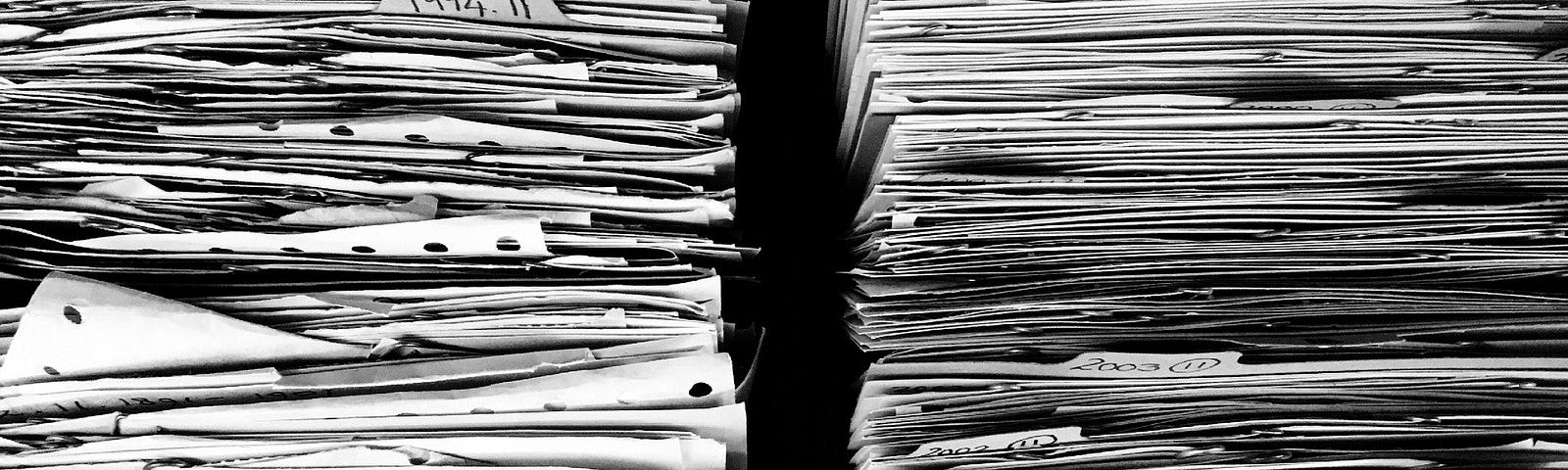 Two very large stacks of paper. Image by Ag Ku from Pixabay