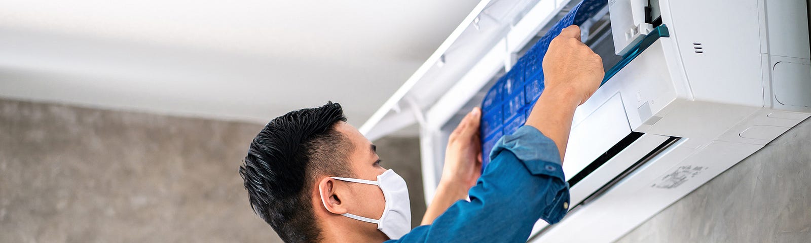 Air conditioner technician cleaning AC