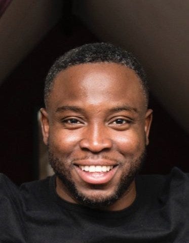 photo of a black man smiling.