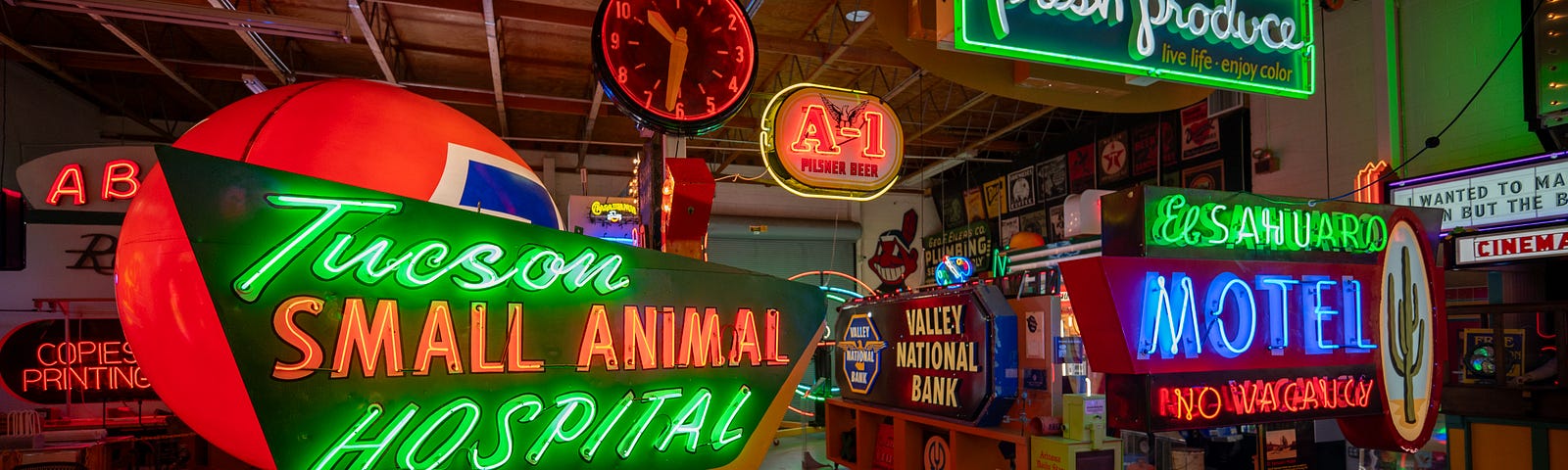 A collection of various neon signs in a darkened room at Ignite Sign Art Museum in Tucson, Arizona