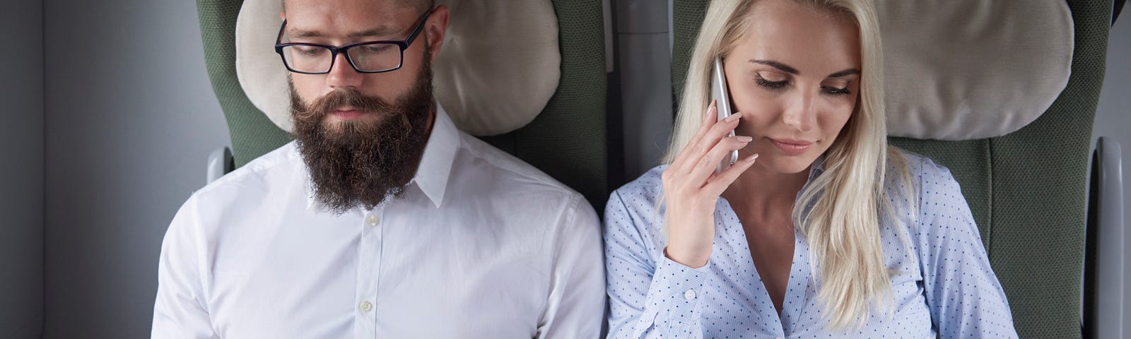 A man and woman sitting next to each other on a flight