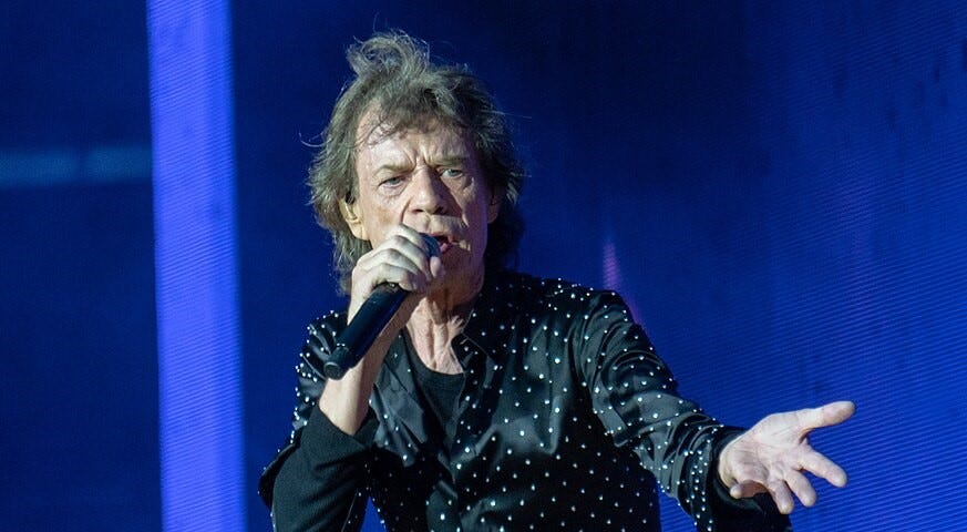 Mick Jagger sings to the audience with his usual enthusiasm.