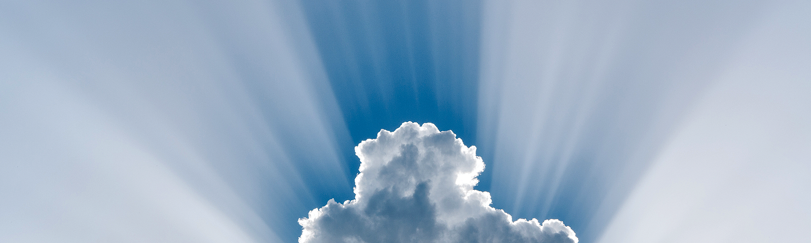 Photo of a cloud with sun rays.