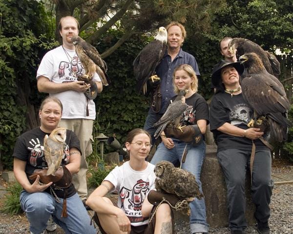 Seven people are holding different types of birds, including owls, eagles, a hawk and peregrine falcon. Leslie Zacher, bottom left, is holding a barn owl. This photo was taken at a Sarvey Wildlife Care Center fundraiser in 2008.