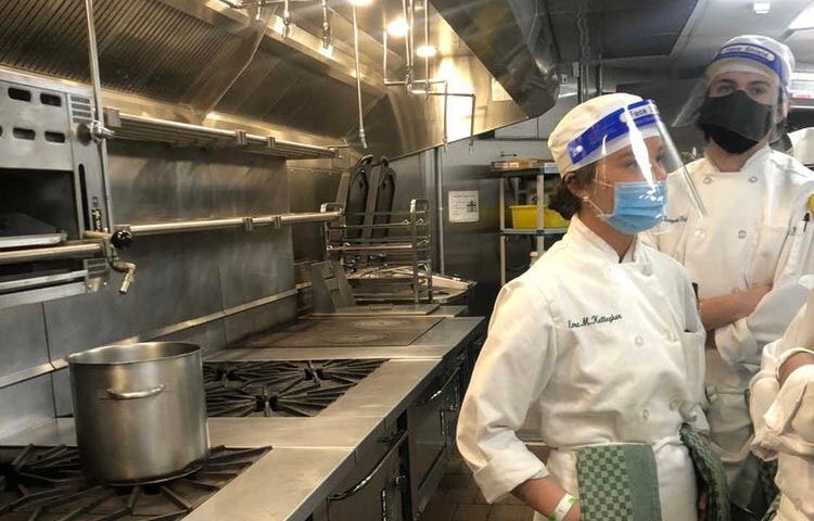 Students at the CIA prepare for class in the kitchen.