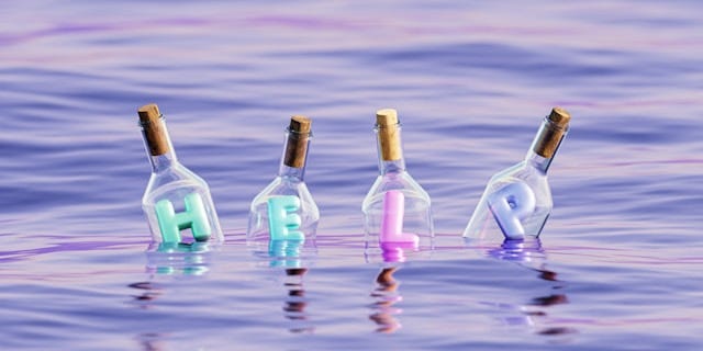 Group of four bottles floating in the water each with its own letter spelling “Help”