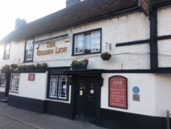 16th century pub The Golden Lion showing its timber beams, public house on the high street