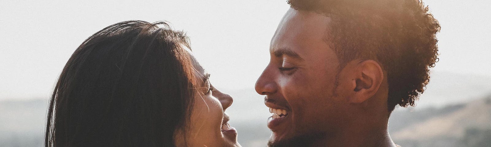 Woman facing a man and smiling